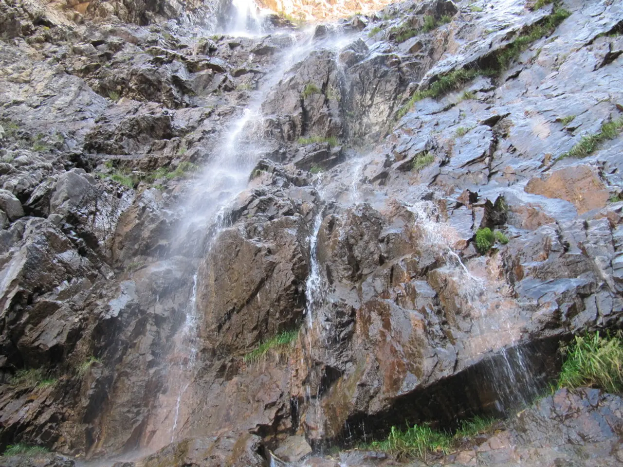 In this picture we can see the close view of the mountain rock with waterfall.