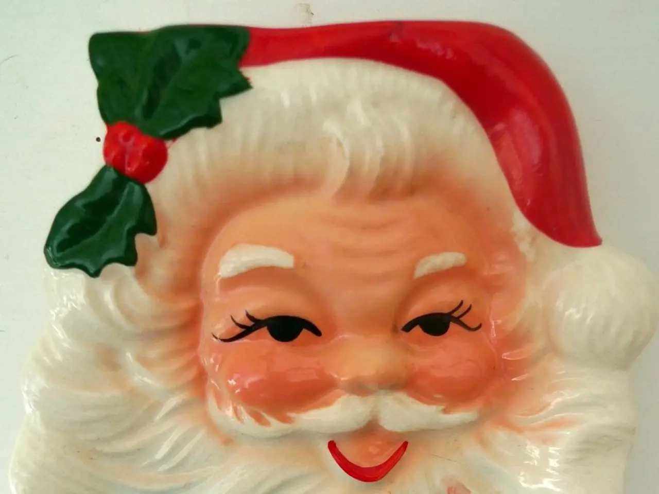 There is a santa claus head on a white surface.