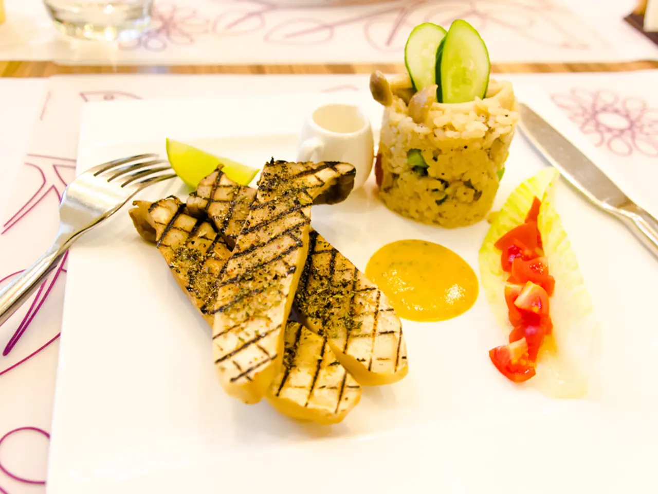 In the image there are some cooked food items served on a plate and there is a fork and a knife...