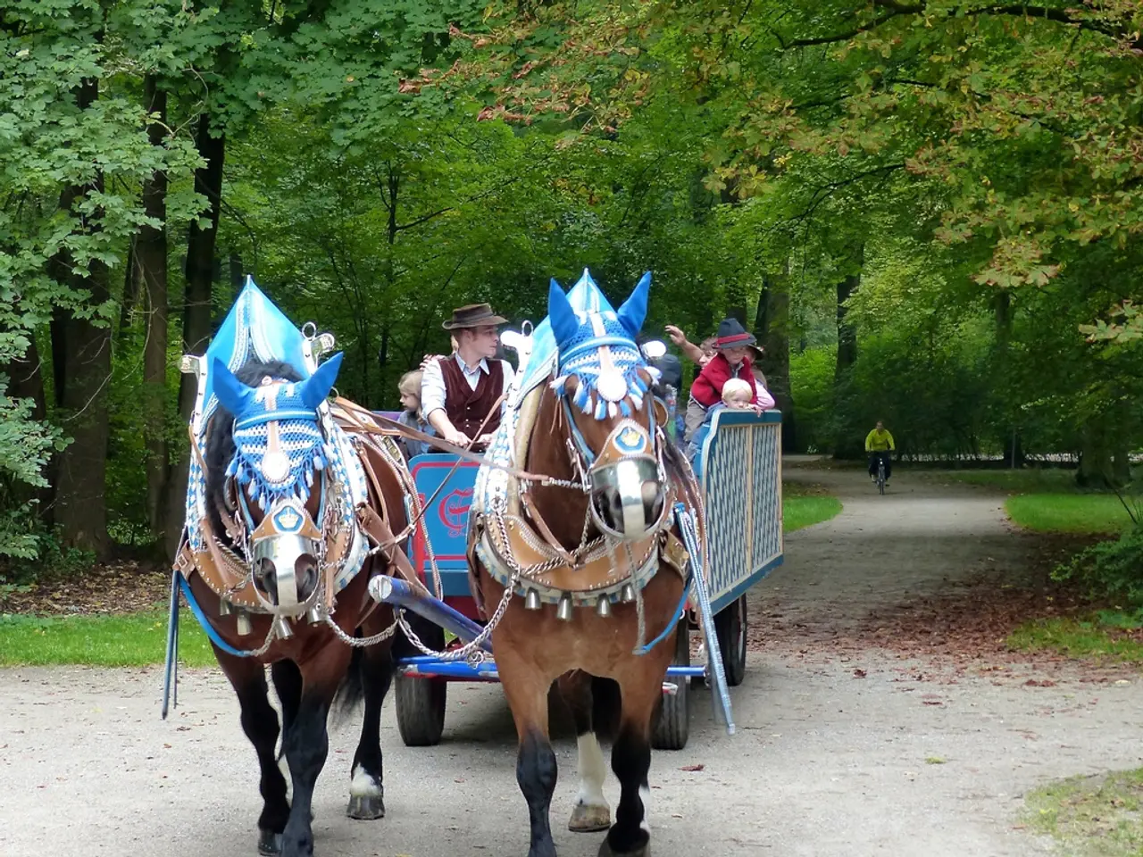In the image there is a horse tanga with few people sitting on it and behind there is a man riding...