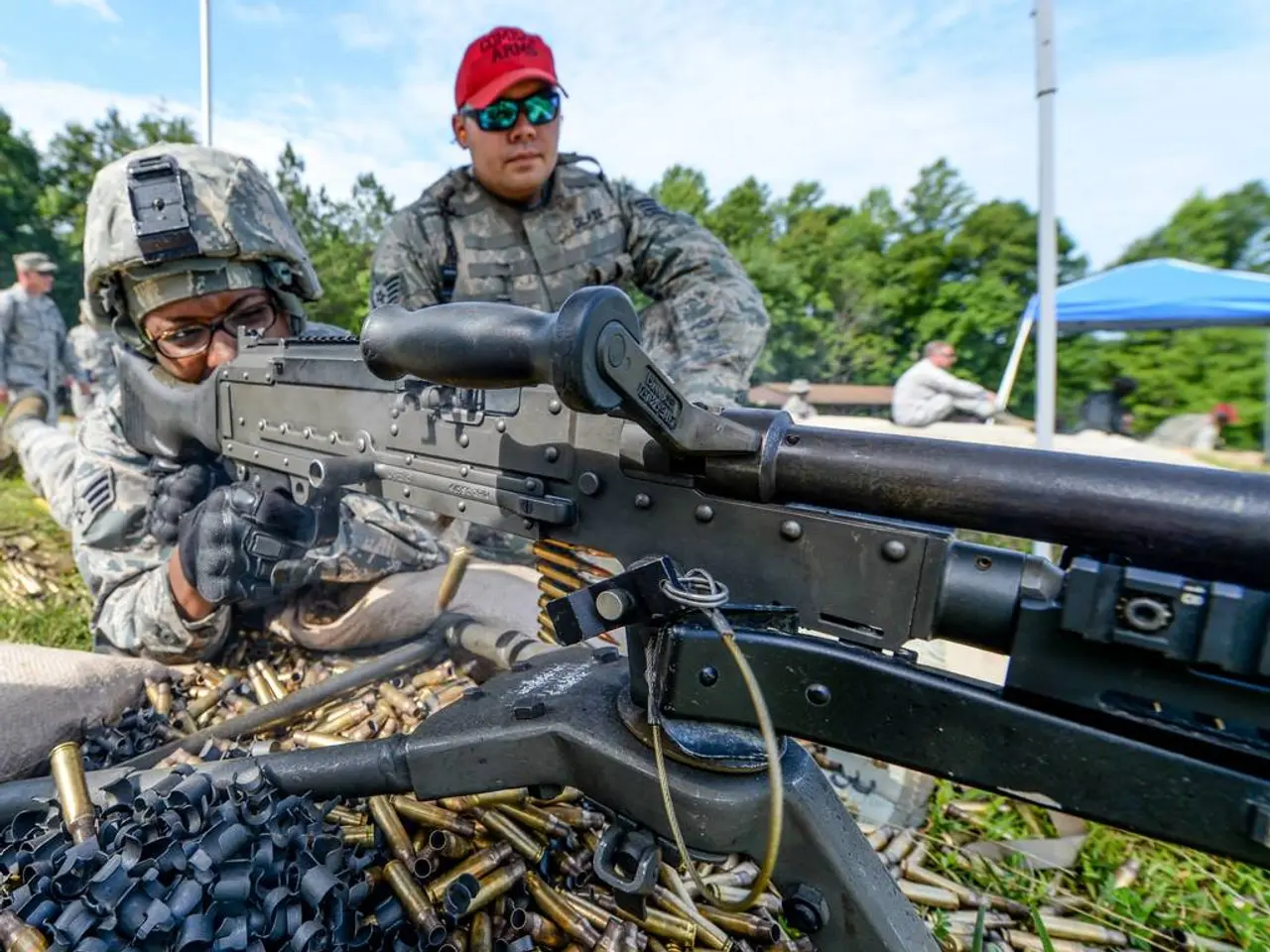 The picture is taken from an army training camp. In the foreground of the picture there is a person...