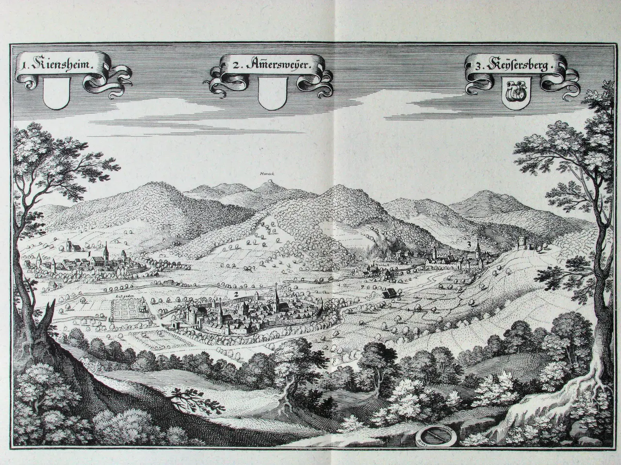 The image shows an open book with a drawing of a landscape featuring trees, hills, buildings, and...