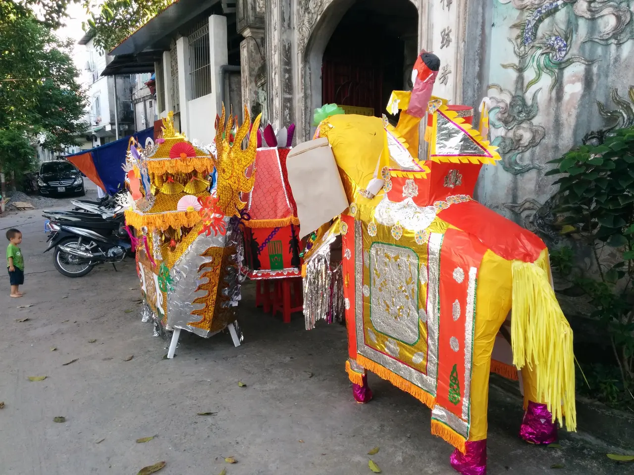 The image shows a vibrant scene of a Chinese New Year parade in Ho Chi Minh City, Vietnam. There...