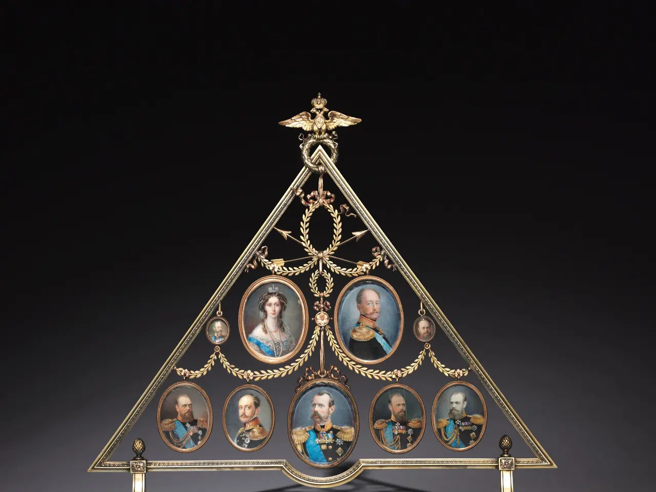The image shows a gilt-bronze and enamel triptych with portraits of Napoleon Bonaparte on a stand....