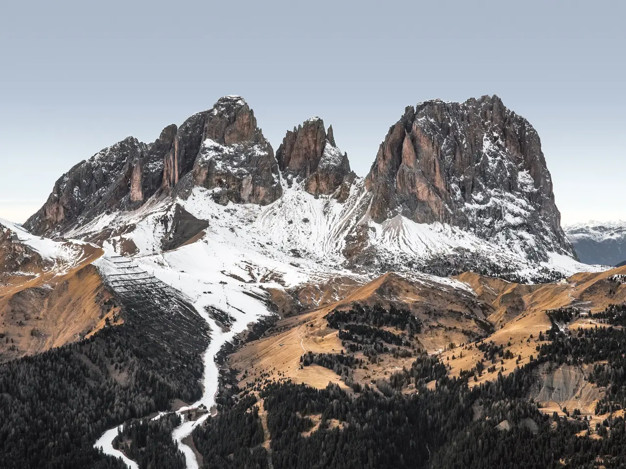 The image shows the majestic Dolomites in the Italian Alps, with snow-capped peaks, lush green...