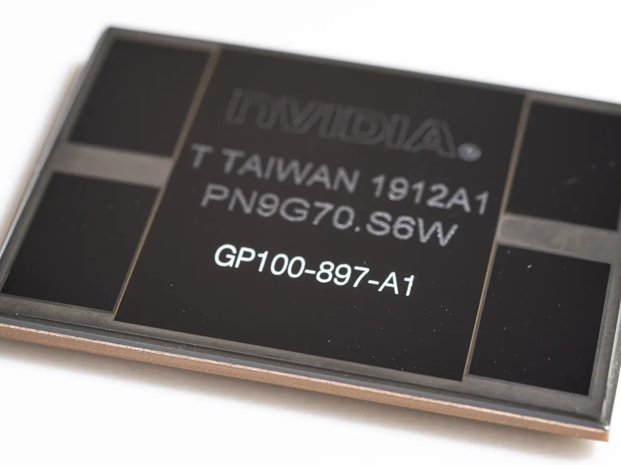 The image shows a close up of a black and brown Nvidia Geforce GTX 660 Ti chip on a white surface...