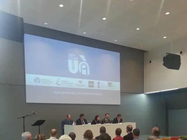 It is like a seminar hall, group of people are sitting on the chairs, opposite to them there is a...