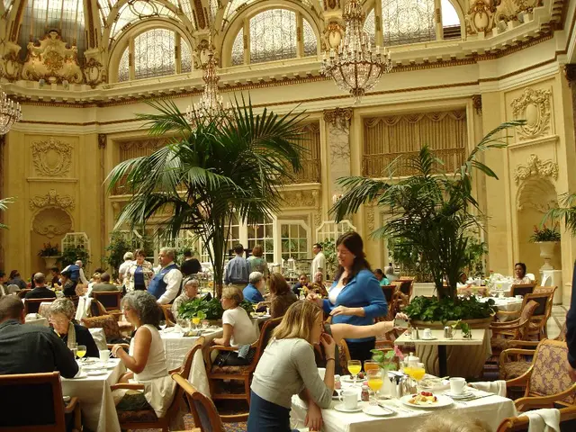 This is the picture of a place like hall where we a have a group of people sitting on the chairs in...