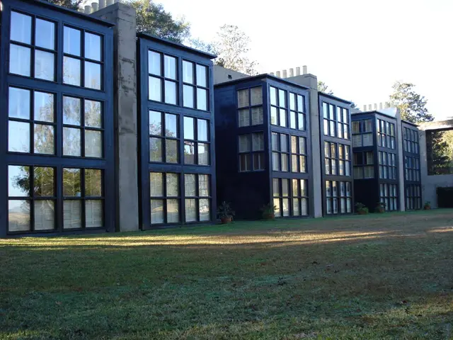 This picture contains similar houses in a row and few trees around.