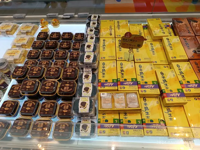 The image shows a display case filled with lots of different types of chocolates, boxes, and other...