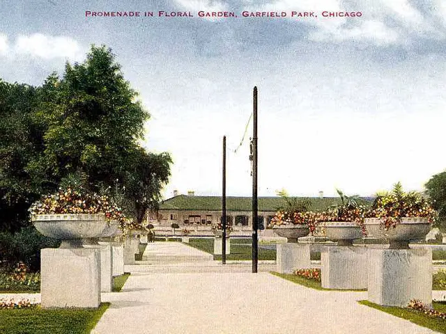 The image shows a promenade in Floral Garden, Garfield Park, Chicago. It features a walkway lined...