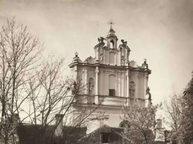 The image shows an old black and white photo of a building with windows, trees, and a sky in the...