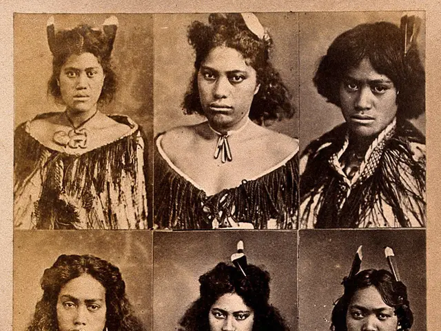 The image shows an old black and white photo of a group of women wearing traditional Native...