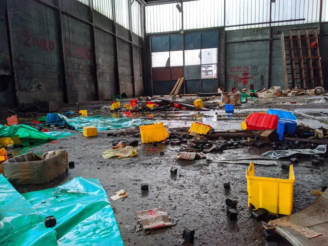 The image shows a large room filled with lots of trash and debris, including plastic covers,...