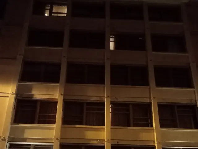 The image shows the Hotel Dame des Arts at night, illuminated by lights and surrounded by...