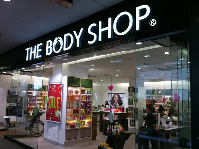 The image shows a body shop in the middle of a shopping mall. Through the glass walls, we can see a...