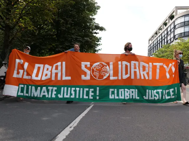 The image shows a group of people walking down a street, holding a banner that reads "Global...