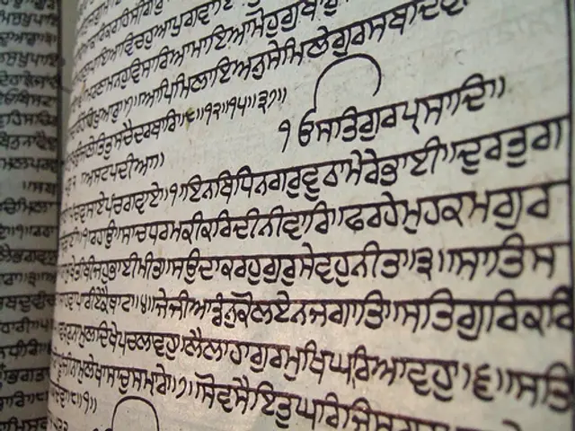 The image shows an open book with Tibetan writing on it. The paper is filled with text, likely from...