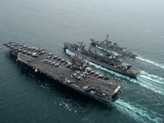 The image shows three aircraft carriers, the USS George H W Bush CVN-68, transiting the Arabian...