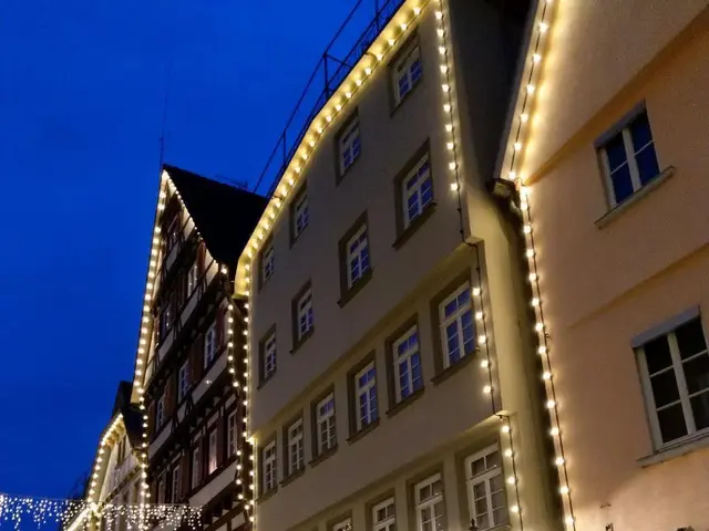 The image shows a cobblestone street in the old town of Rothenburg ob der Tauber, Germany,...