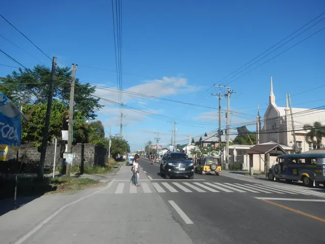 The image shows a city street with cars and people crossing the street in front of a church. There...