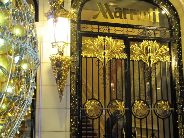 The image shows the entrance to Marriott Hotel in New York City, with a metal gate adorned with...