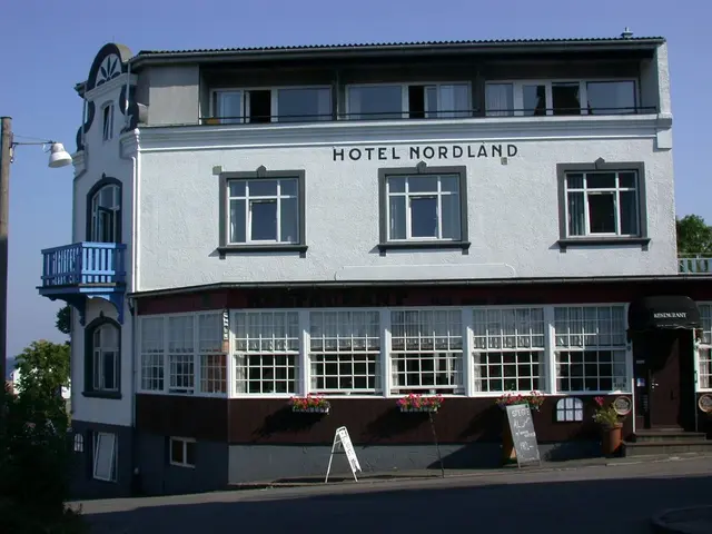 The image shows the Hotel Nordland in Stavanger, Norway. It is a building with windows, a signboard...