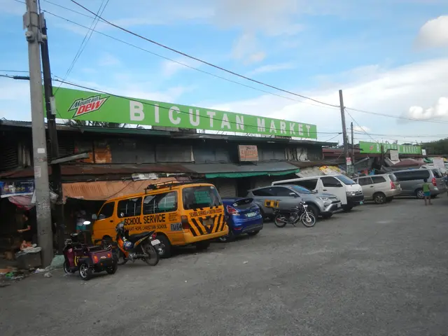 The image shows a bustling bicutan market in Cebu City, Philippines. There are vehicles on the...
