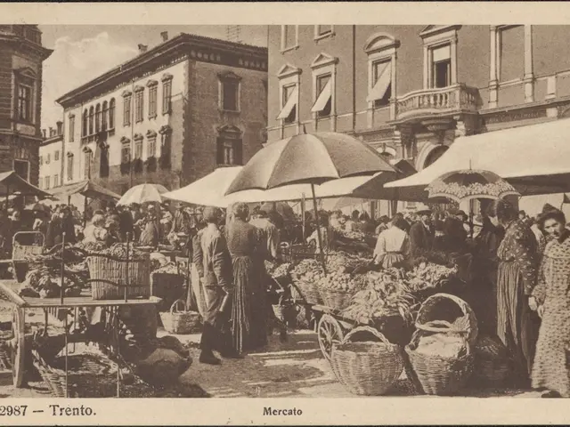 The image shows an old black and white photo of a bustling market in Trento, Italy. There are many...