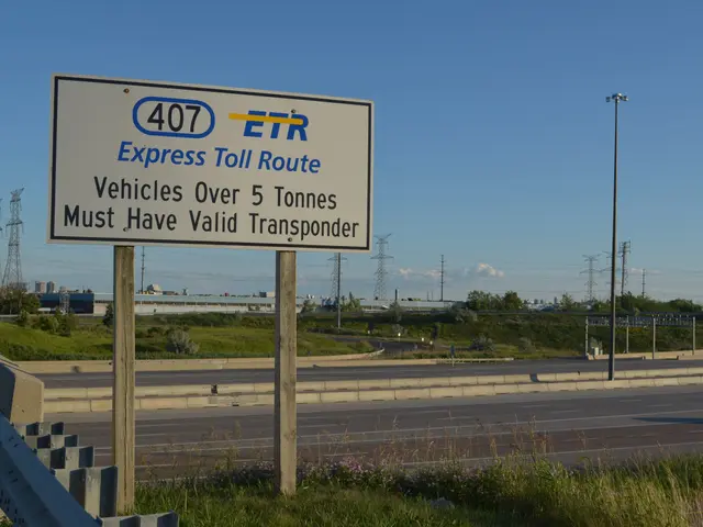 The image shows a highway with a sign on the side of it that reads "Express Toll Route". There is a...