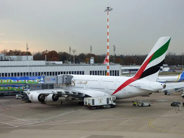 The image shows an Emirates Airbus A380-800 at Frankfurt Airport, surrounded by vehicles and...