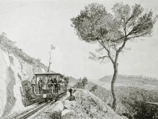 The image shows an old black and white photo of a train going down the tracks, with a few people...