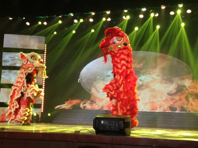 The image shows a stage with two lion dancers performing on it, illuminated by lights and...