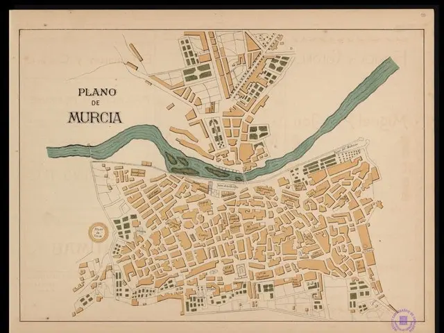 The image shows an old map of the city of Murcia, Spain, framed in a photo frame. The map is...